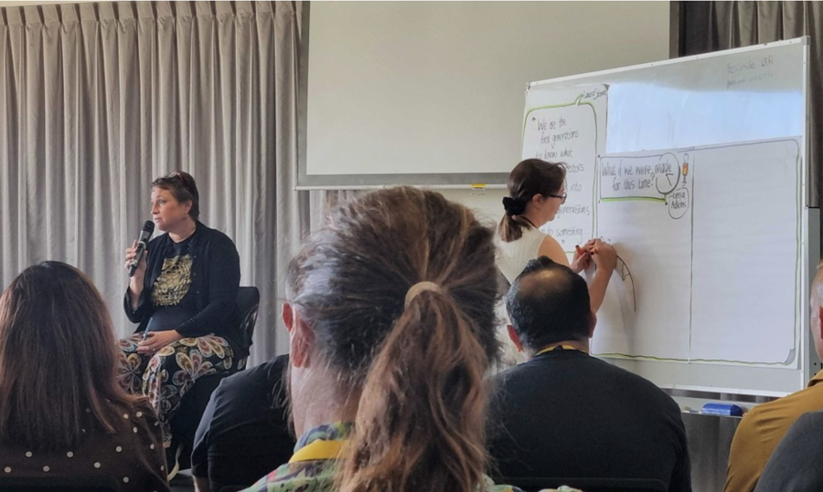 Participants watching a live sketch at Agile on the Beach